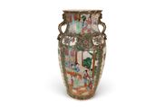 a vase with a painting on it on a white surface