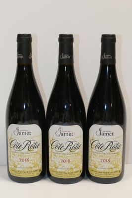three bottles of wine are lined up on a table