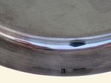 a silver plate on a table with a white background