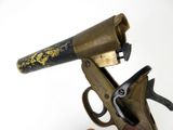 a gun that is on top of a wooden stand
