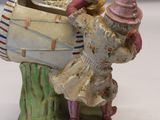 a figurine of a man and a woman with a boat