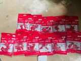 a pile of red bags of toothbrushes on the floor