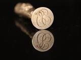 a close up of a pair of silver cufflinks on a black surface