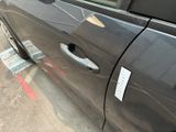 a black car with a sticker on the side of it ' s door