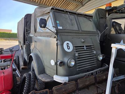 a military truck that is parked in a garage