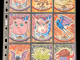 pokemon trading cards are displayed on top of a binder