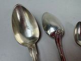 three spoons that are sitting next to each other on a table