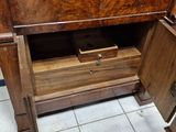 a wooden cabinet that has a drawer in it