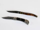 pair of two knives with silver and wood handles on a white surface