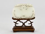 a small sculpture of sheep on a stand on a white background