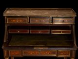 a desk with drawers and a bench on it