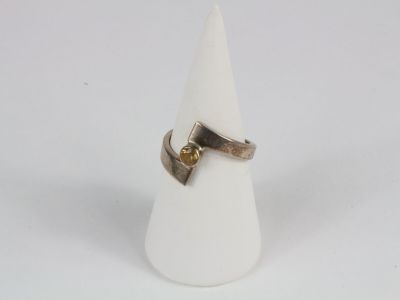 silver and gold ring with a yellow diamond