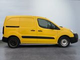 the yellow van is parked on the concrete floor in the room