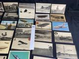 a lot of old photos of airplanes on the table