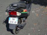 a motor scooter that is parked on the side of the street