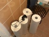 two rolls of toilet paper sitting on the floor in the bathroom
