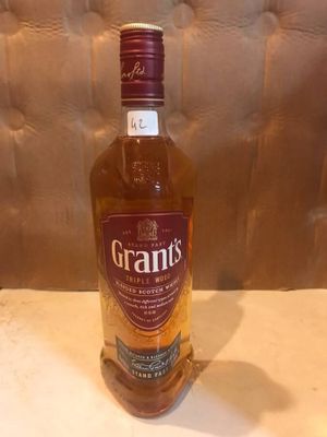 the bottle of grant ' s is sitting on a table
