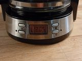 a coffee maker that is sitting on a wooden table