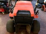 a red tractor that is parked in a garage
