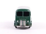 a toy bus that is sitting on a white surface