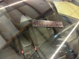 a sticker on the windshield of a car that is parked