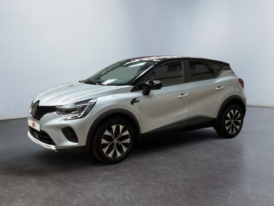 une voiture argentée garée dans une pièce blanche au sol noir