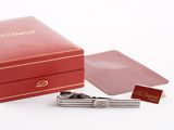 a red box with a tie bar and a pen in it
