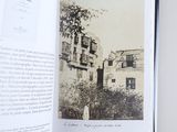 an open book with a black and white photo of a building
