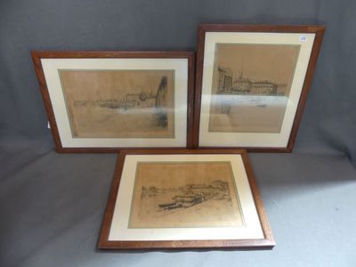 three framed drawings of boats and buildings on display in a wooden frame