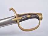 a close up of a sword on a white surface