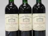 trois bouteilles de vin rouge posées côte à côte sur une table