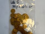 a bag of gold coins on a white surface