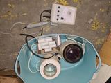 a blue tray with a camera and some wires on it