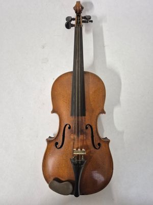 a close up of a violin on a wall with a white background