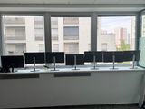 a picture of a room with a lot of computers on the desks