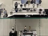 a lot of watches on display in a glass case