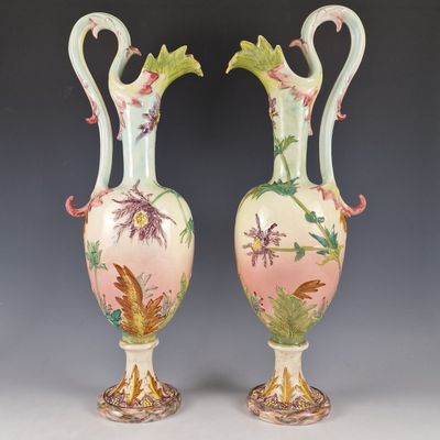 pair of vases with birds and flowers painted on the sides of them