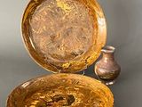 two bowls and a vase sitting on a table