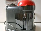 a red and gray blender sitting on a counter