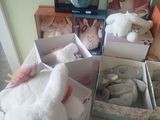 many stuffed animals that are in boxes on the floor