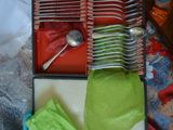 many forks and spoons in a box on a table