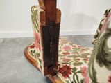 a chair that has a wooden handle on it