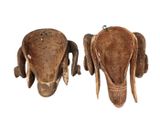 pair of wooden elephant head ornaments on a white background