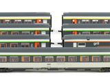 three model trains sitting side by side on a white surface