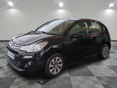 the black citrole is parked in the garage on a checkered floor