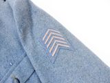 a close up of a blue jacket with a chevroned design on it