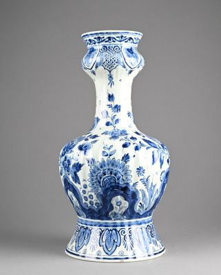 blue and white vase with a floral design on the bottom