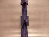 a wooden statue of a man with a hat on