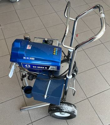 a small blue machine sitting on the floor in a room
