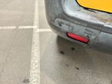 a close up of the rear end of a yellow car